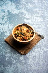 Oats Chivda / Chiwda is a healthy indian recipe with added chilli, peanuts, cashew, almond and curry leaf for flavour. Selective focus