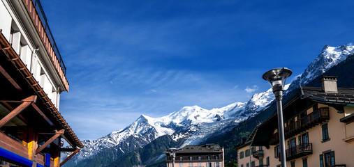 Breathtaking scenery of the Alps from Chamonix France. Chamonix downtown in summer. Beautiful buildings on a sunny day of summer. River, flowers, colorful facades.