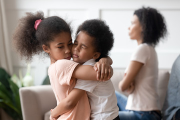 Little african kids embracing passing through divorce of parents together