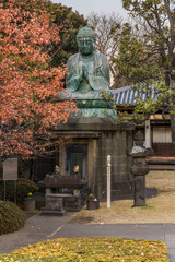 Giant bronze statue depicting the Buddha Shaka Nyorai in the Tendai Buddhism Tennoji temple in the Yanaka cemetery of Tokyo.