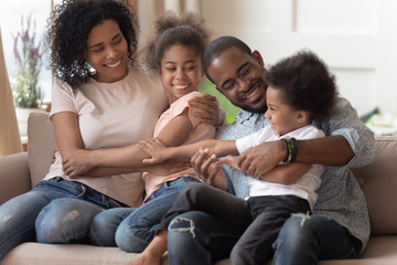 Cheerful african family funny spending time together at home