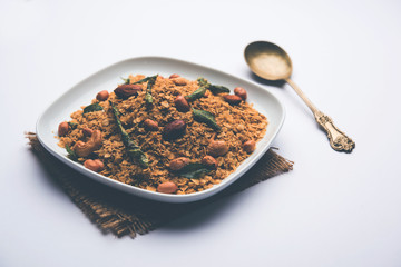 Oats Chivda / Chiwda is a healthy indian recipe with added chilli, peanuts, cashew, almond and curry leaf for flavour. Selective focus