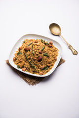 Oats Chivda / Chiwda is a healthy indian recipe with added chilli, peanuts, cashew, almond and curry leaf for flavour. Selective focus
