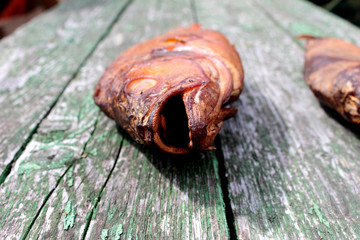 Smoked fish lies on a wooden board