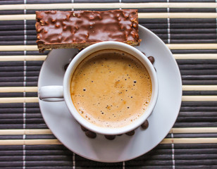 Hot morning coffee for breakfast on a sunny weekend with a slice of cake.