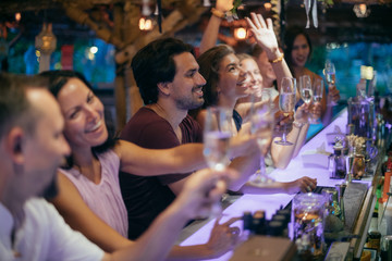 Friends celebrate the New Year at the bar behind the bar.