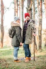 Hiking couple with backpack walking in the forest and exploring outdoors. Freedom and active travel concept.