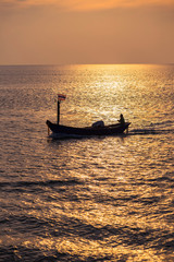 The fisherman took a boat to shore after going fishing on Beautiful sunrise