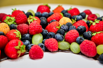Healthy food concept. Photo of raspberries, blueberries, wild strawberries on a white background.
