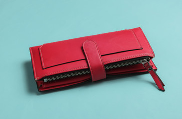Red leather wallet on blue background.