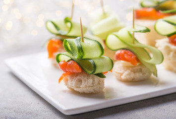 Christmas tree canape or sandwich with cucumber slice, salmon  for festive x-mas snack. New year recipe