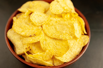 potato chips in a bowl, beer snacks on a stone background