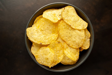 potato chips in a bowl, beer snacks on a stone background