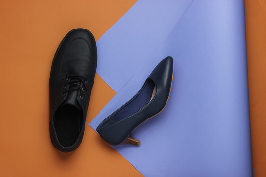 Male and female leather shoes on colored  background. Top view