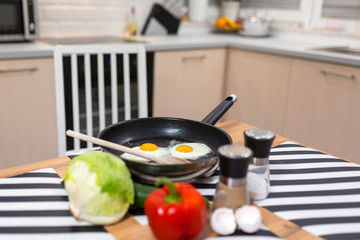 Fried eggs on pan in the kitchen