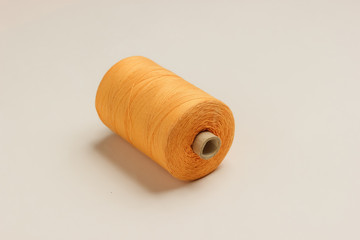 Orange skeins of thread on white background. Top view