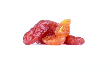 Dried sweet tomatoes cut in half and full piled on a white background.