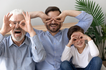 Funny head shot portrait grandfather, father and son, three generations