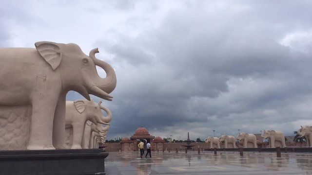 Time lapse of Ambedkar Public Park in Lucknow. The dark and heavy clouds are floating above the sequence of elephant sculptures