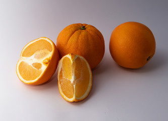 Fresh oranges on white and dark background