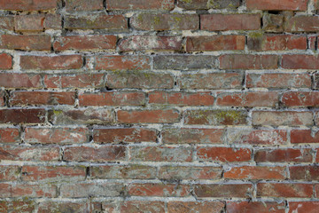 Old brick wall with cracks and scratches. Horizontal wide brickw