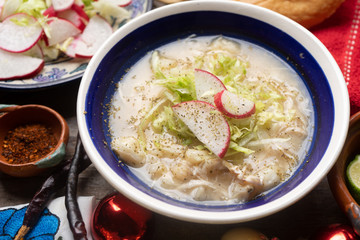 Mexican white  pozole with christmas decoration on wooden background