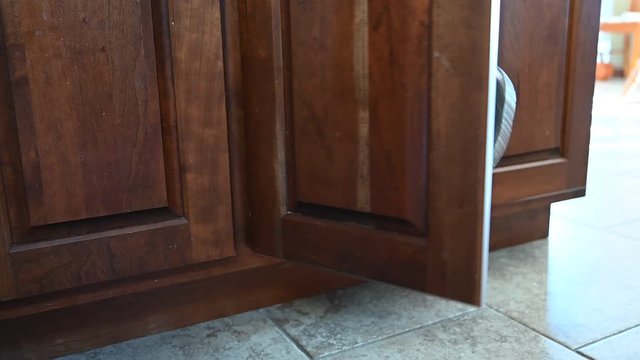 pots and pans falling out of kitchen cabinet once door is opened