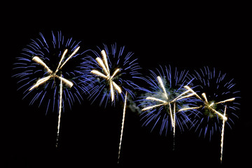 Fototapeta na wymiar Flashes of blue, white festive fireworks