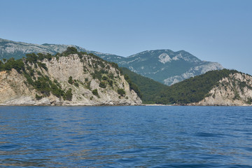 Mountains on the coast covered with forest.