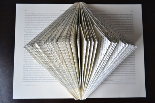folded book in front of black background