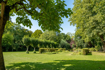 Parks are one of the best places to rest. Street view of beautiful historic city center architecture of Bruges or Brugge, West Flanders province, Belgium. Lovely summer August weather