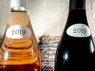 close up of neck two bottles of Beaujolais Nouveau 2019, red and rosé