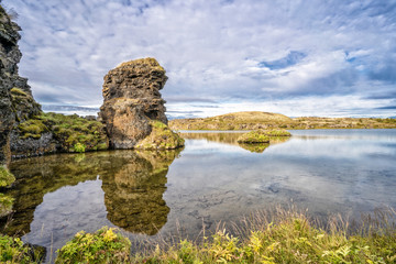 Fototapeta na wymiar tranquil landscape with solitary lava monoliths at Lake Myvatn in northern Iceland