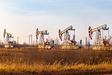 Oil rocking in the field. Oil production in Russia, Republic of Bashkortostan. Industrial landscape. Autumn