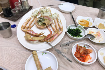 served crab on plate and various korean banchan