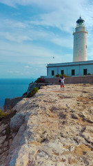 Fototapeta na wymiar the beautiful lighthouse on the cliff overlooking the island of Formentera in the Balearic Islands