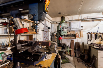 Russia, Moscow- July 06, 2019: interior machines in garage workshop. old machinery repair and production equipment.