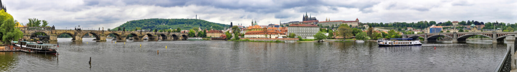 Naklejka na ściany i meble Panoramic view of the Vltava River flowing through the centre of Prague 