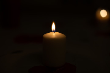 Candle on black background. Candle lighting in the room.