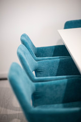 chaises bleu autour d'une table blanche carré de réunion dans un espace de coworking
