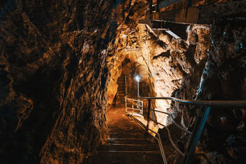 Descent into limestone caves for speleological sightseeing