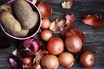 Fresh potatoes and onions on the table