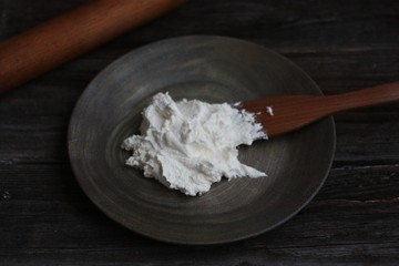 Fresh cottage cheese on a wooden table