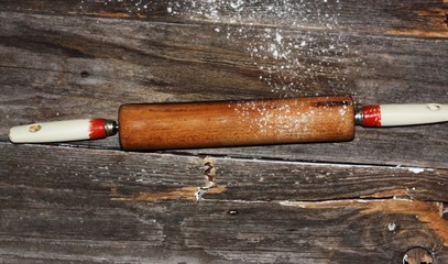 Old wooden rolling pin on the table