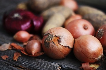 Fresh potatoes and onions on the table