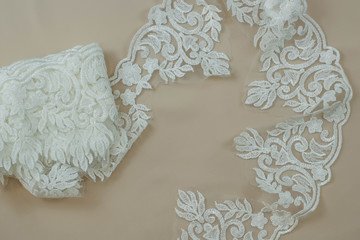 Obraz premium Texture lace fabric. lace on white background studio. thin fabric made of yarn or thread. a background image of ivory-colored lace cloth. White lace on beige background.