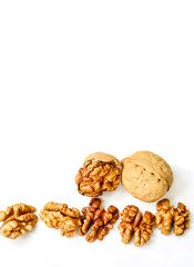 Walnut kernels and whole walnut isolated on white background. Copy Space. Close up. Healthy eating concept.