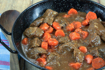beef and carrot cooked in a dish