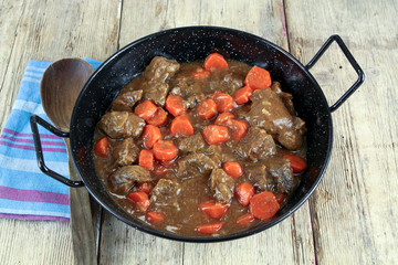 beef and carrot cooked in a dish
