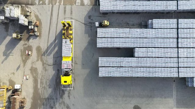 Aerial view of warehouse with truck and forklift stacker . Industrial background. Logistics from above. Industry in European Union.
